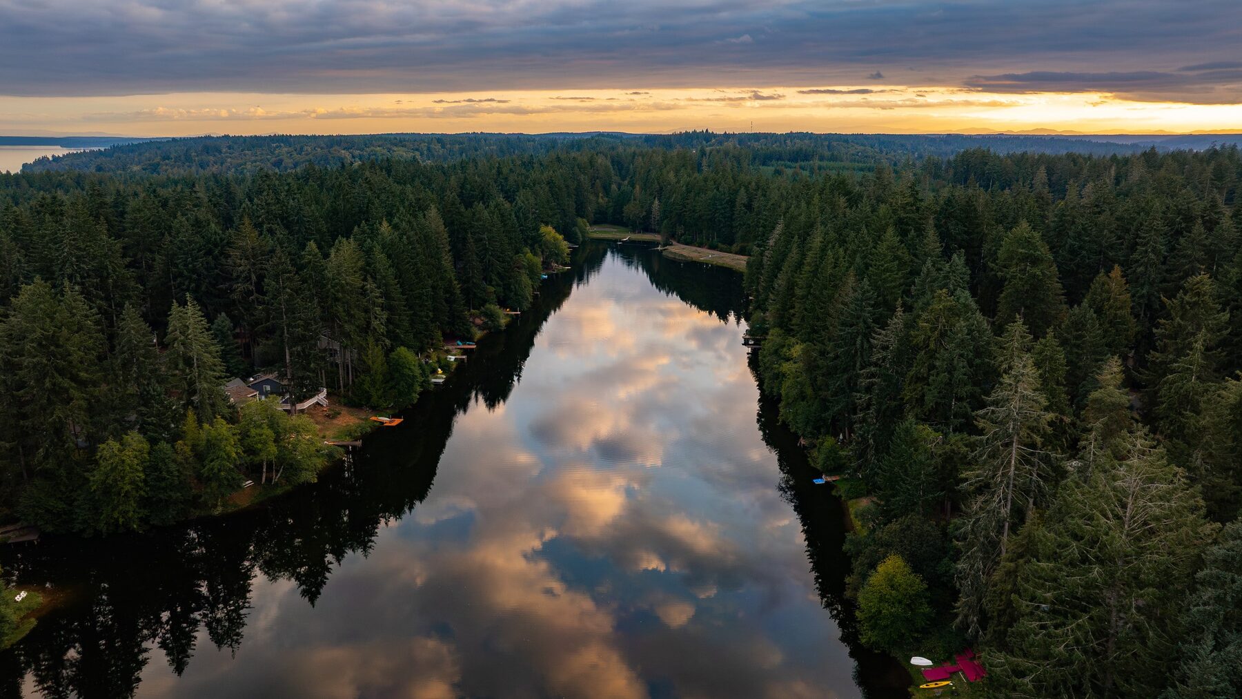 Aerial view of Lake Minterwood at sunset with the cabin among the trees on the shoreline