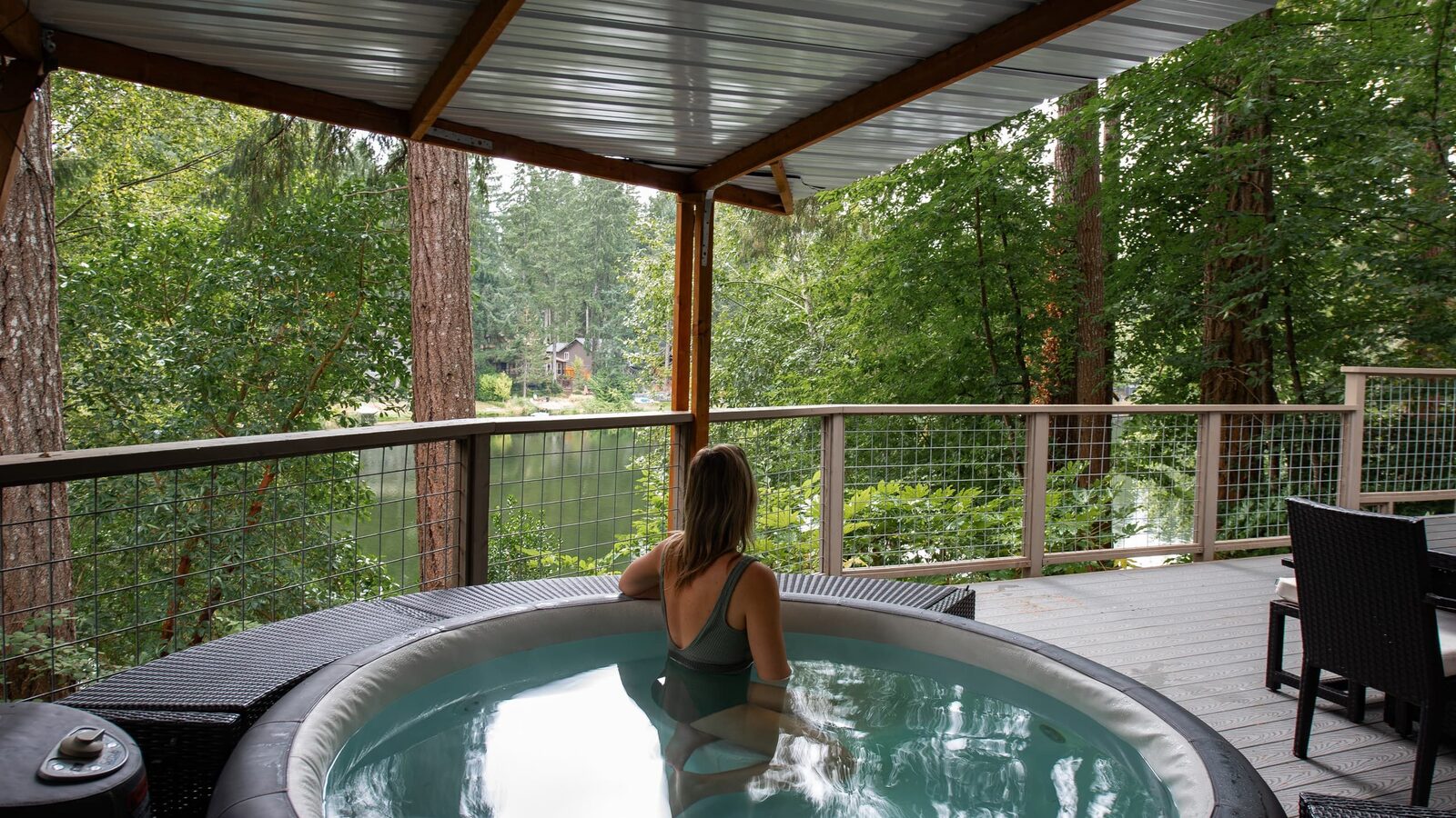 Soaking in the covered hot tub on the deck looking out over Lake Minterwood