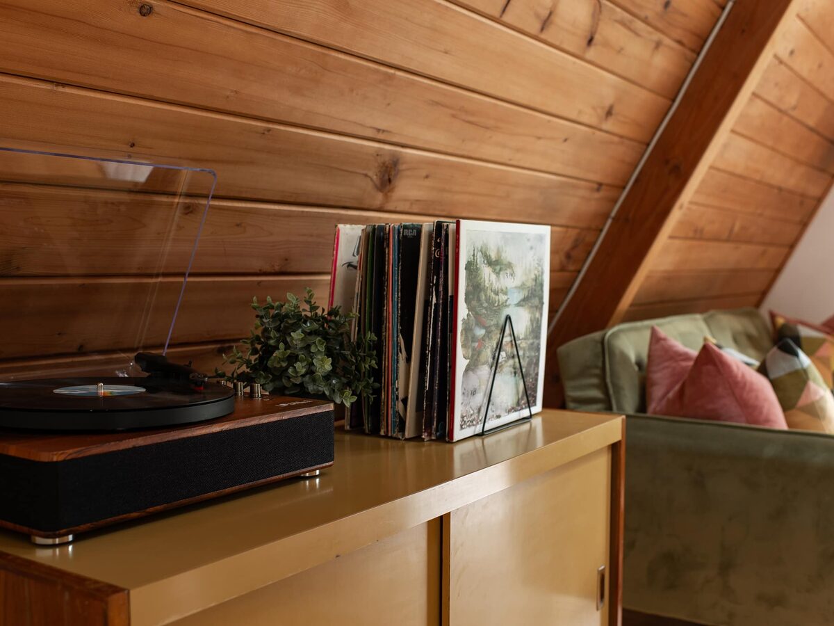 Record player and vinyl collection on the console in the main level living area