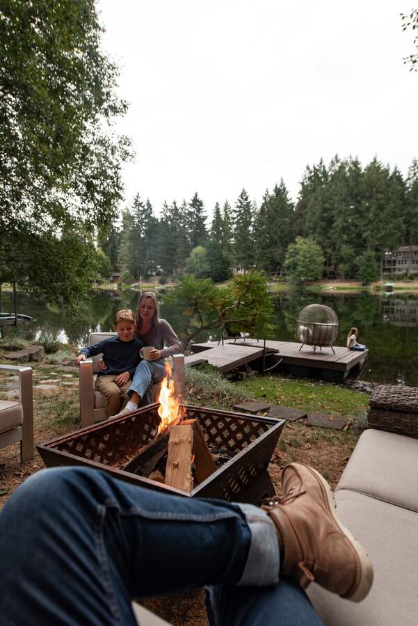 Tending the lakeside fire pit in the backyard on a summer evening