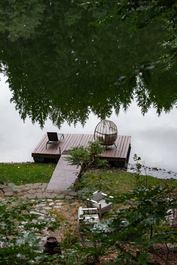 The lawn and dock under the big shade tree at the water's edge