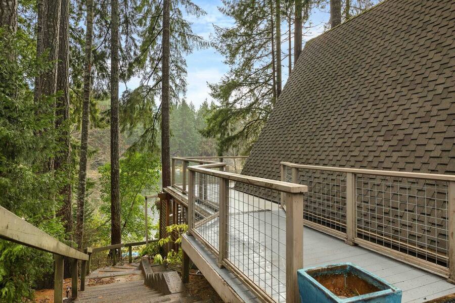 The deck walkway past the hot tub toward the lake