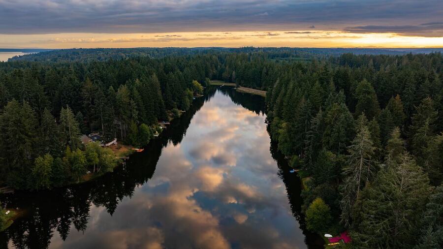 Aerial view of Lake Minterwood at sunset with forest along both shores